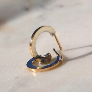 side view of mixed metal hoop stud earrings with 10K gold edge and gold posts